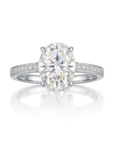 Classic oval moissanite ring with four prong setting and pavé band in white gold | SARATTI