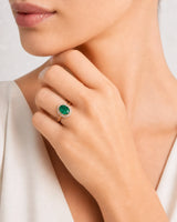 Classic oval natural emerald ring with round diamond halo in rose gold | SARATTI