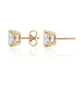 1.00 ct. tw. lab-grown round diamond four-prong studs in 18K yellow gold, prong detail | SARATTI