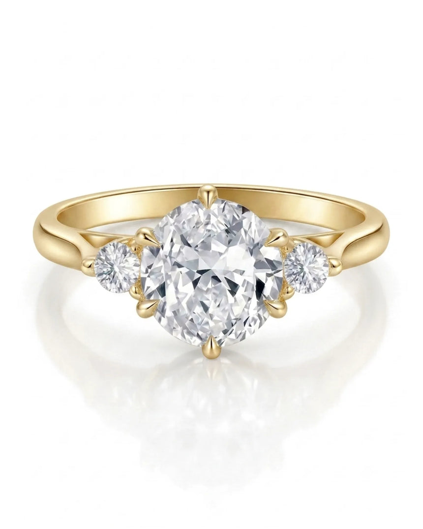 Classic round moissanite ring with two side stones in polished 18K yellow gold | SARATTI