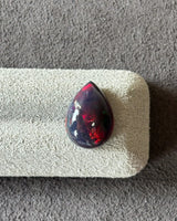 Close-up of Ethiopian Black Opal showing red orange green and blue flashes | SARATTI