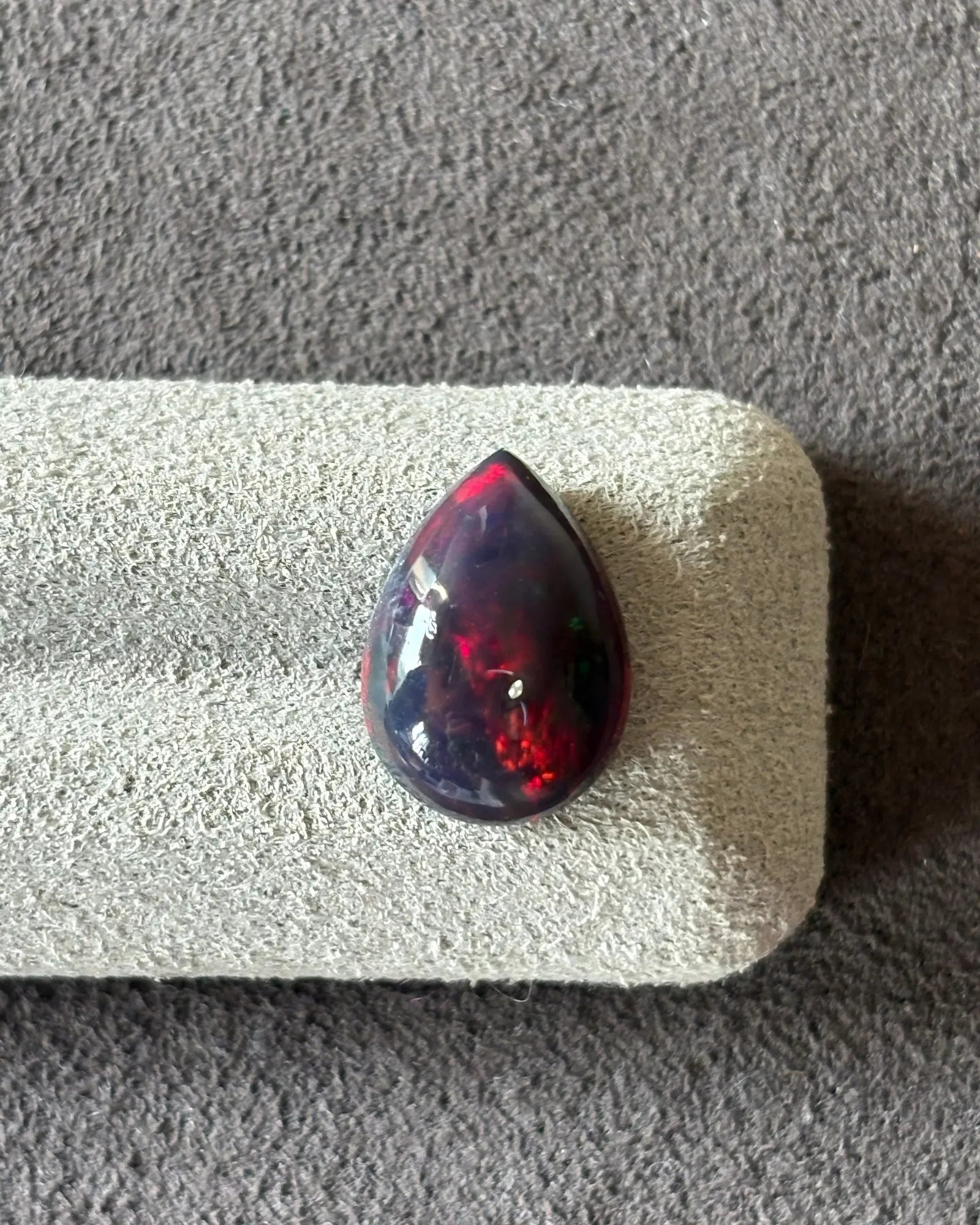 Close-up of Ethiopian Black Opal showing red orange green and blue flashes | SARATTI