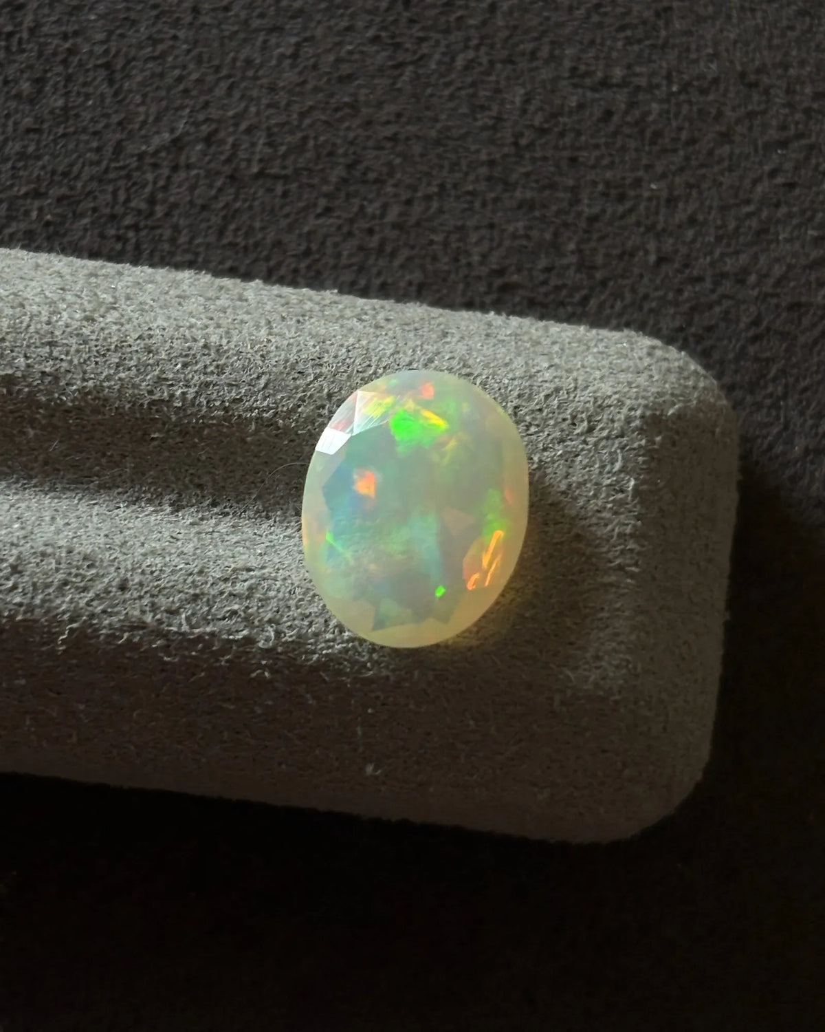 Close-up of Ethiopian White Opal showing vivid orange and green play-of-colour | SARATTI