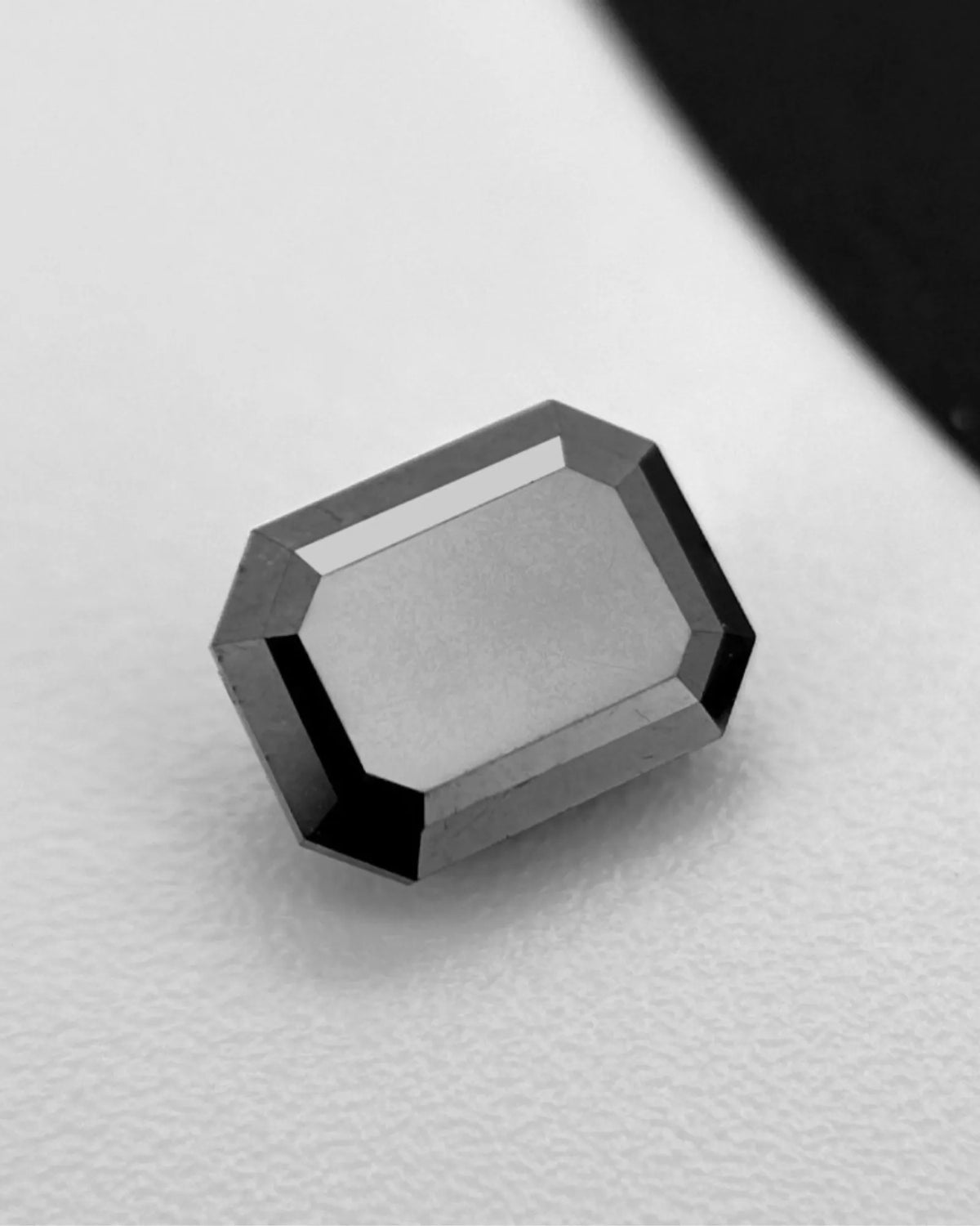 Close-up of Natural Black Diamond step-cut facet reflections | SARATTI
