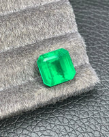 Close-up of broad step-cut facets on a Vivid Green Natural Emerald | SARATTI
