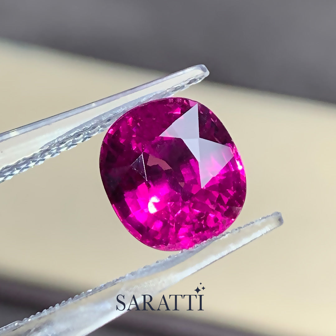 Close-up of neon pink Mahenge garnet faceting | SARATTI