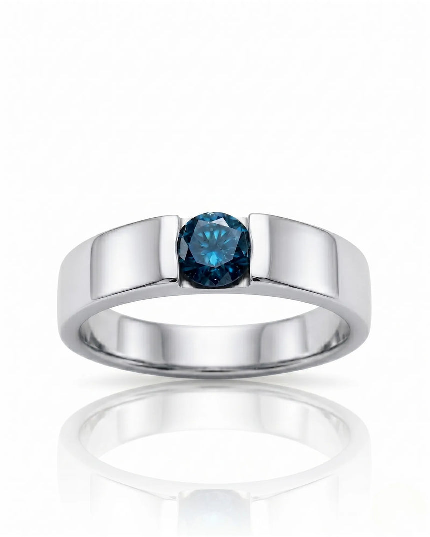Close-up of round treated blue diamond secured without side stones in polished 18K white gold | SARATTI