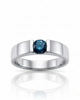 Close-up of round treated blue diamond secured without side stones in polished platinum | SARATTI