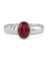 Close up natural ruby ring showing oval red gemstone in polished 18K white gold | SARATTI