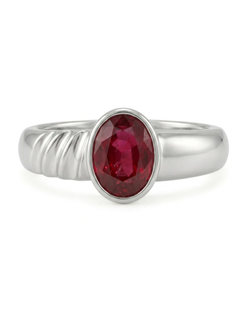 Close up natural ruby ring showing oval red gemstone in polished 18K white gold | SARATTI