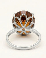Cognac Imperial Topaz engagement ring featuring an oval center and six-petal platinum setting | SARATTI