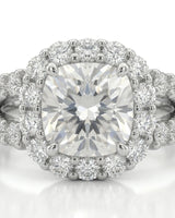 Colorless cushion moissanite framed by round stones with a coordinating platinum eternity band | SARATTI
