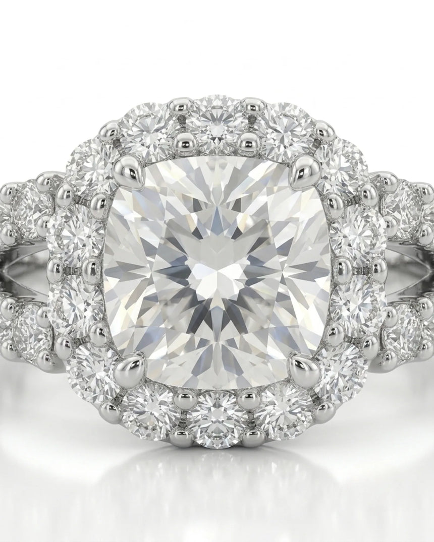 Colorless cushion moissanite framed by round stones with a coordinating platinum eternity band | SARATTI