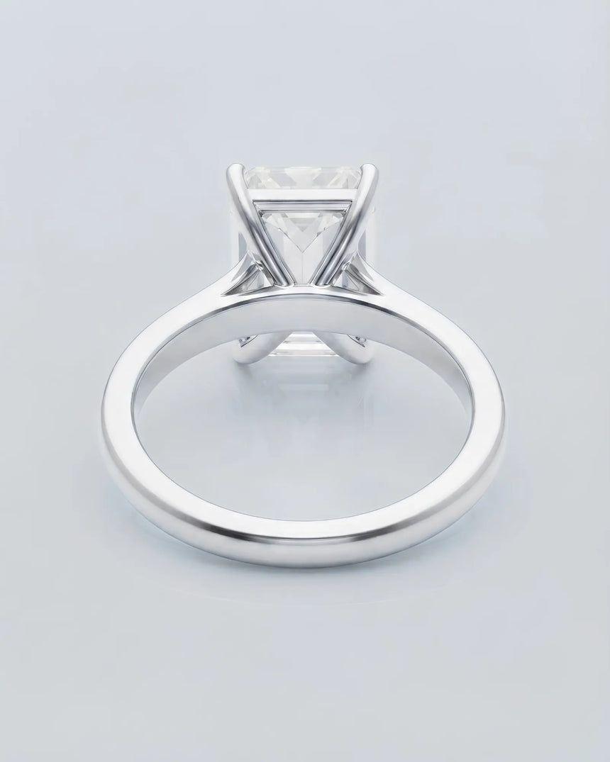 Colorless emerald-cut moissanite ring with step-cut facets and refined platinum setting | SARATTI