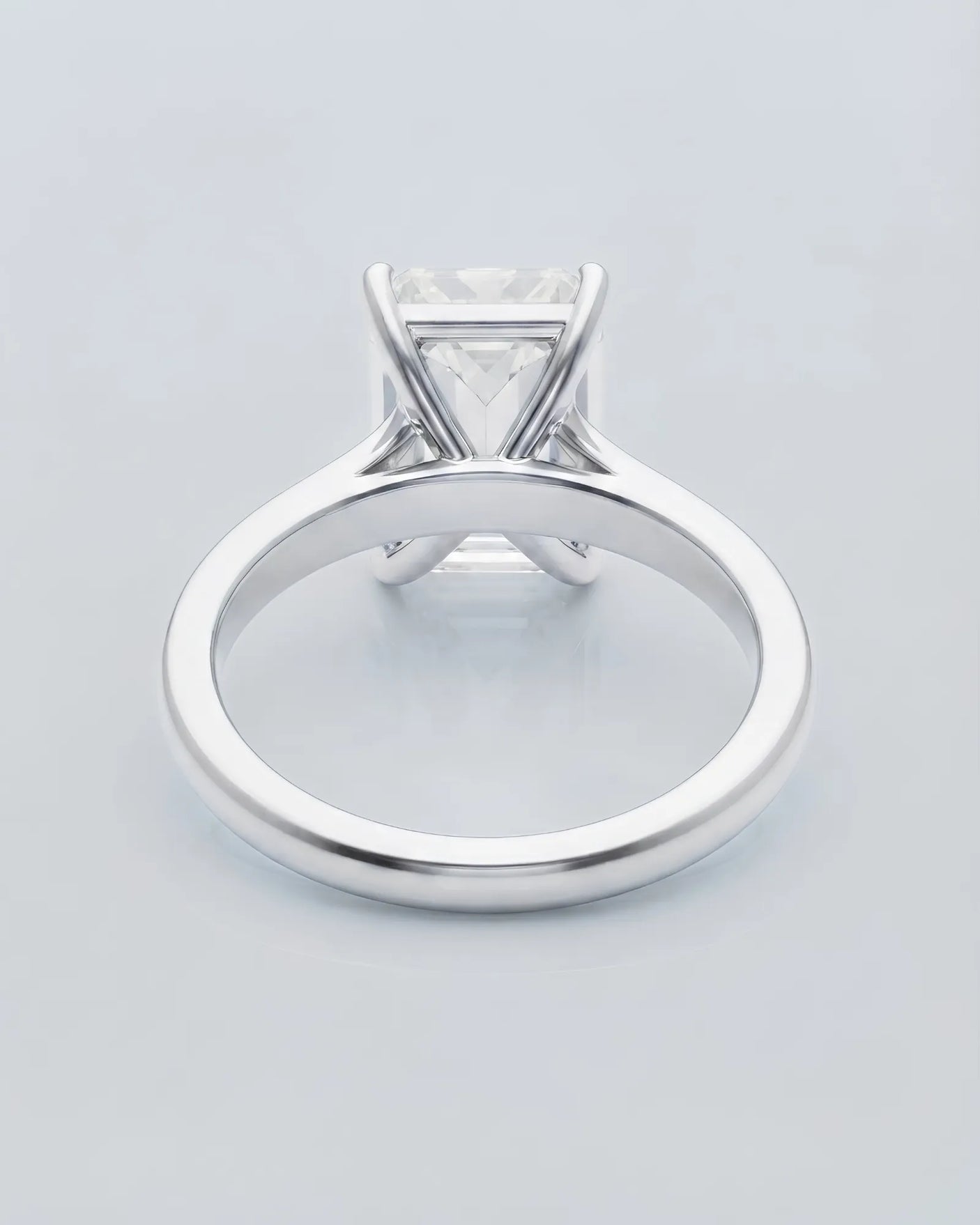 Colorless emerald-cut moissanite ring with step-cut facets and refined white gold setting | SARATTI