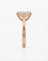 Colorless emerald-cut moissanite ring with step-cut facets and romantic rose gold setting | SARATTI