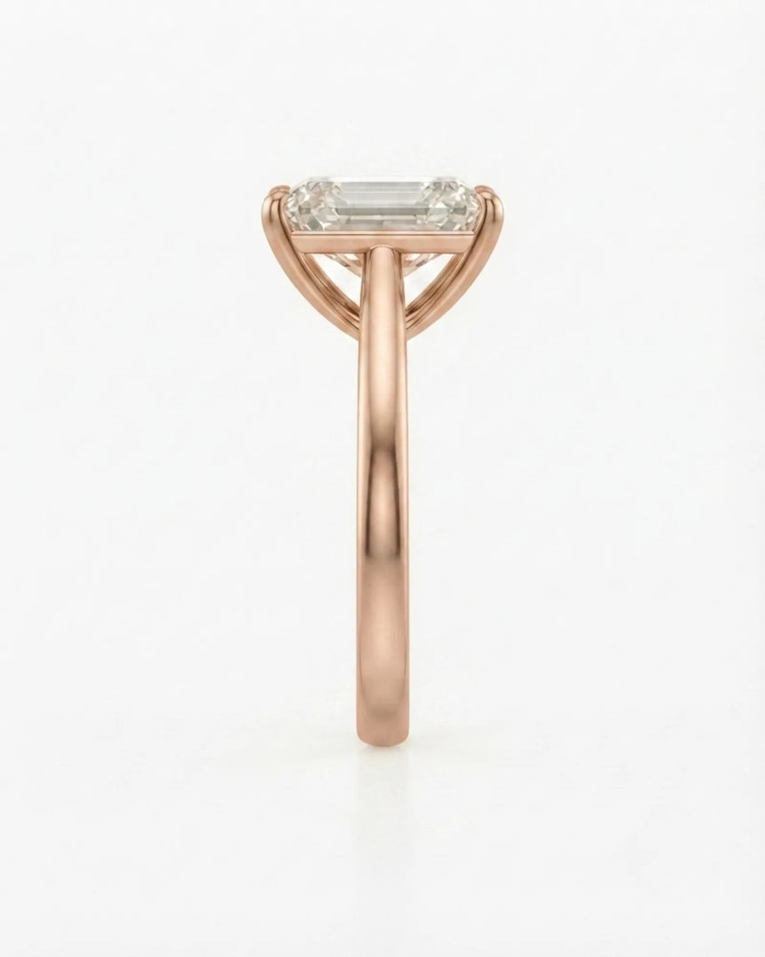 Colorless emerald-cut moissanite ring with step-cut facets and romantic rose gold setting | SARATTI
