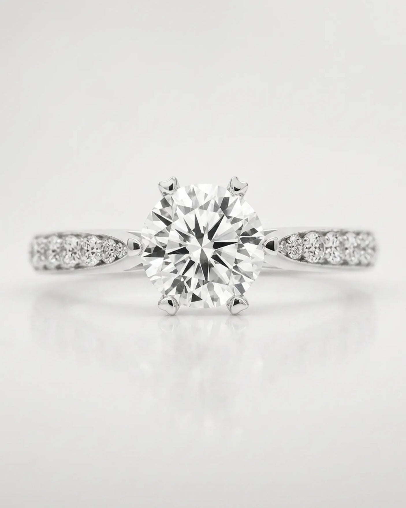 Colorless moissanite center with hidden gallery accents in polished 18K white gold | SARATTI