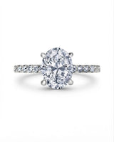 Colorless oval moissanite center with round pavé accents in polished platinum | SARATTI