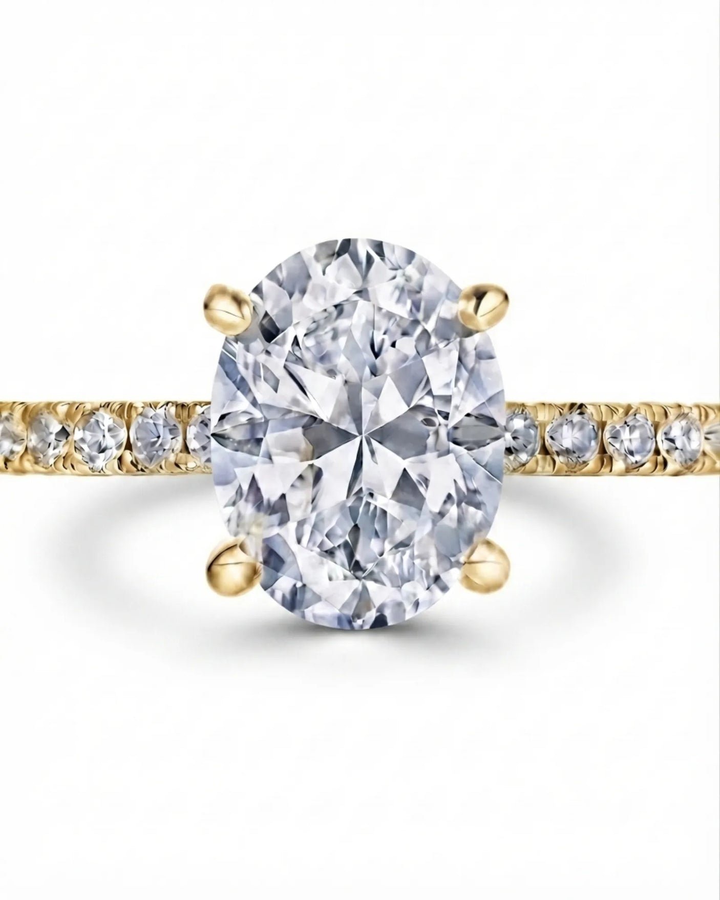 Colorless oval moissanite center with round pavé accents set in yellow gold | SARATTI