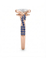 Colorless oval moissanite framed by vivid blue sapphires in polished rose gold | SARATTI