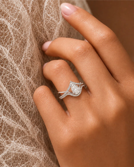 Colorless pear-shaped moissanite center framed by brilliant round accent stones in enduring platinum - SARATTI