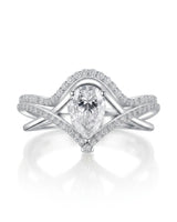 Colorless pear-shaped moissanite center framed by brilliant round accent stones in enduring platinum | SARATTI