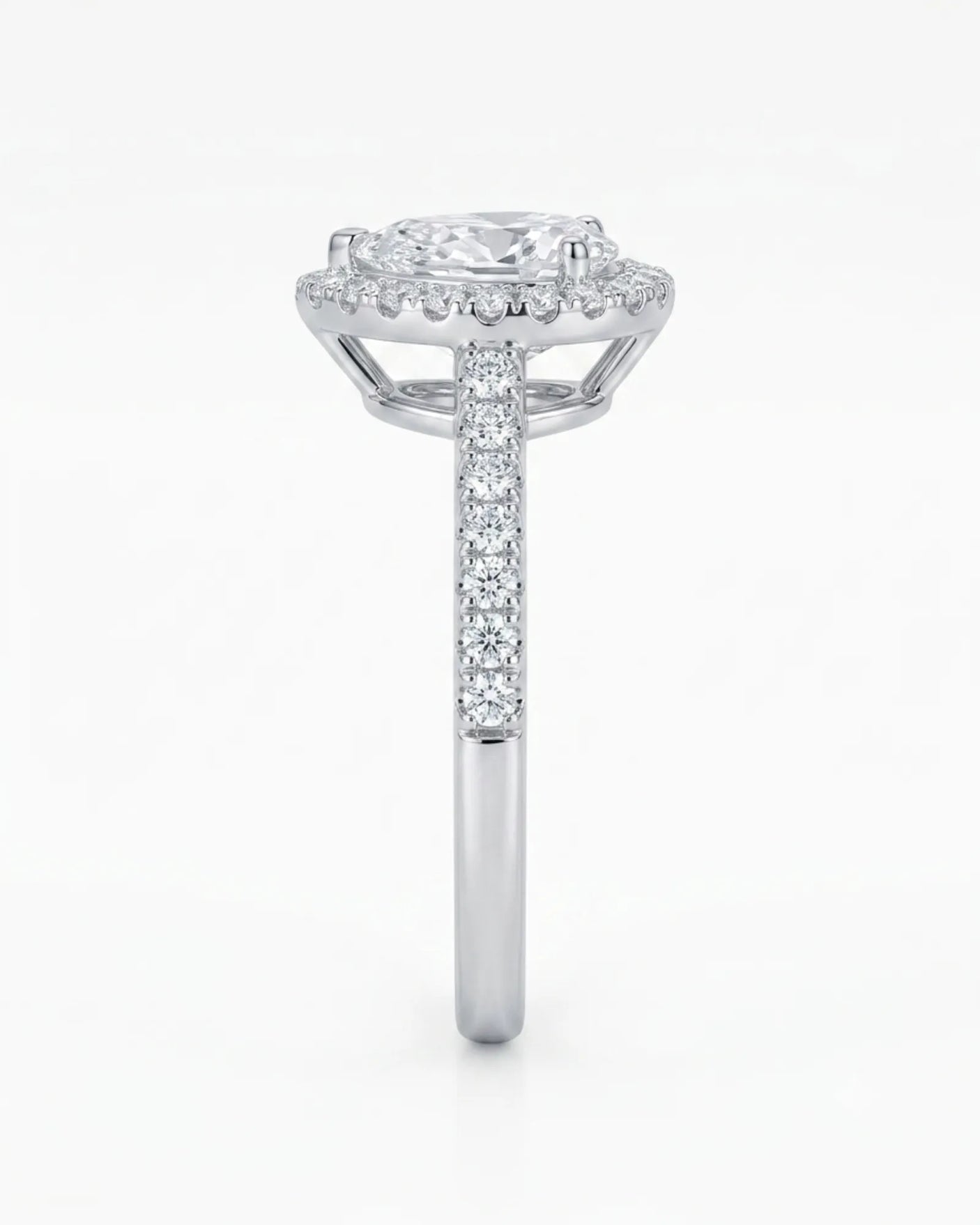 Colorless pear cut moissanite framed by brilliant round moissanite accents in polished platinum | SARATTI