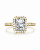 Colorless radiant-cut moissanite surrounded by round accents in warm yellow gold | SARATTI