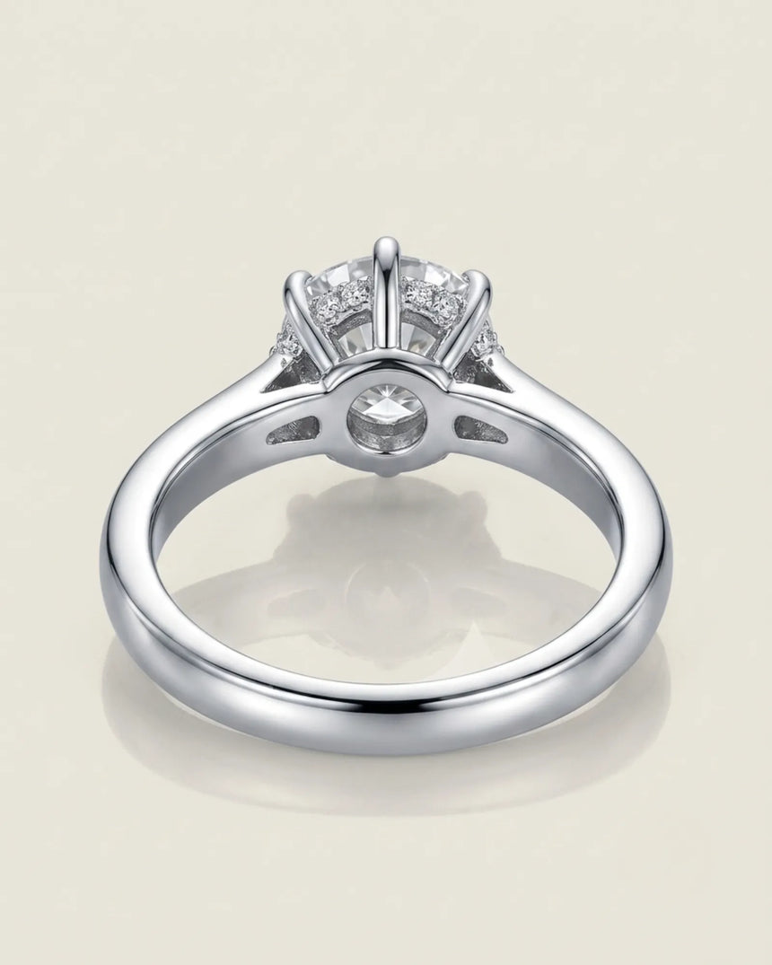 Colorless round moissanite framed by an eight-prong platinum flower-inspired crown | SARATTI