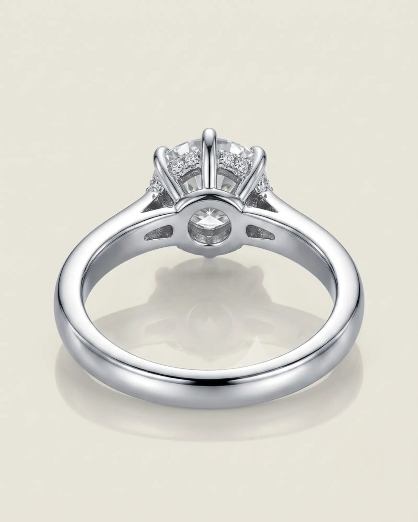Colorless round moissanite framed by an eight-prong white gold flower-inspired crown | SARATTI