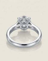 Colorless round moissanite framed by an eight-prong white gold flower-inspired crown | SARATTI