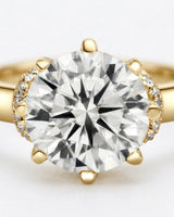 Colorless round moissanite framed by an eight-prong yellow gold flower-inspired crown | SARATTI