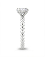 Colorless round moissanite ring framed by four platinum prongs and rhythmic spherical detailing | SARATTI