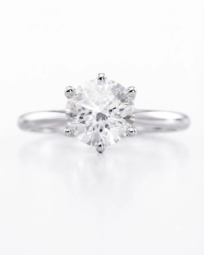 Colorless round moissanite ring with open gallery and elevated platinum six-prong profile | SARATTI