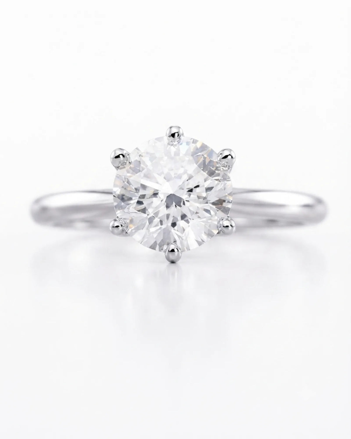 Colorless round moissanite ring with open gallery and elevated white gold six-prong profile | SARATTI