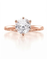 Colorless round moissanite ring with open gallery and romantic rose gold six-prong profile | SARATTI