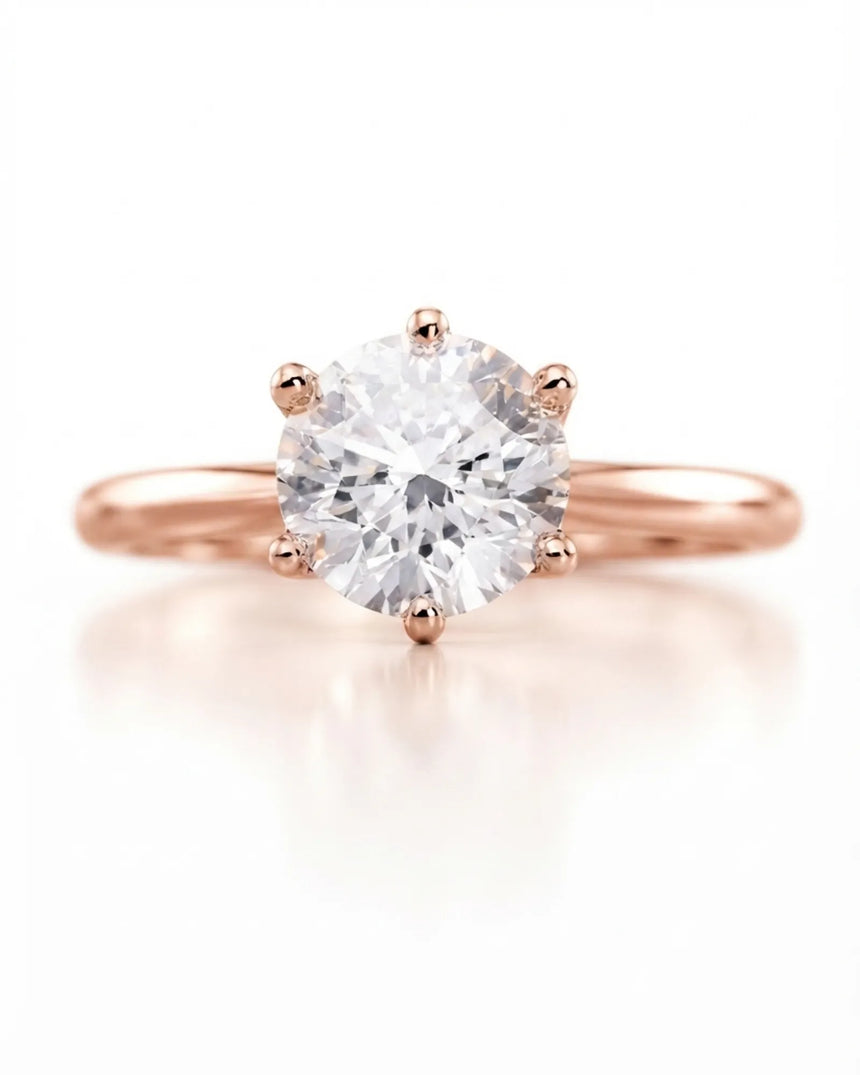 Colorless round moissanite ring with open gallery and romantic rose gold six-prong profile | SARATTI
