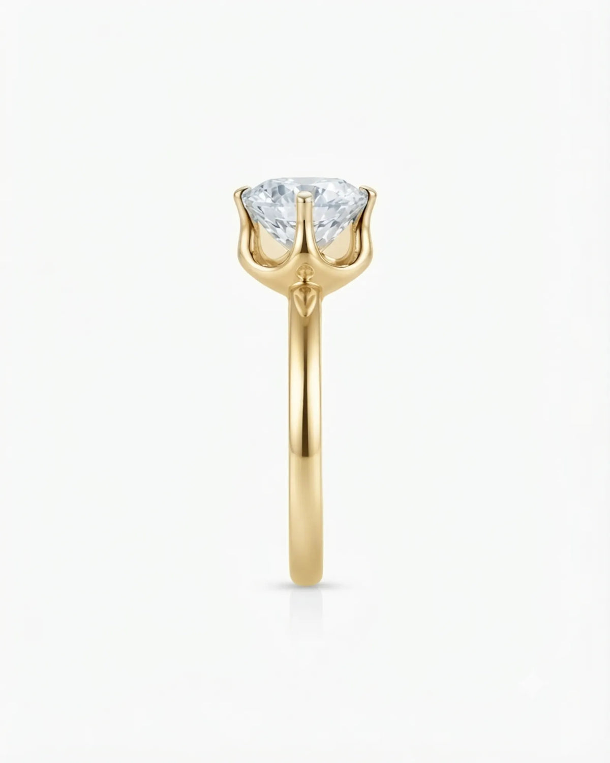 Colorless round moissanite ring with open gallery and warm yellow gold six-prong profile | SARATTI