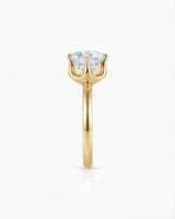 Colorless round moissanite ring with open gallery and warm yellow gold six-prong profile | SARATTI