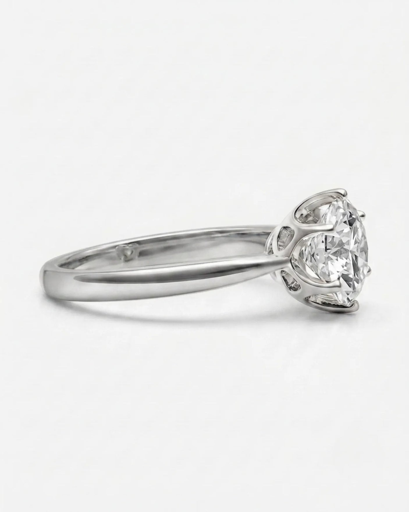 Colorless round moissanite solitaire ring with platinum six-prong crown | SARATTI