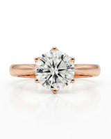 Colorless round moissanite solitaire ring with warm rose gold six-prong crown | SARATTI