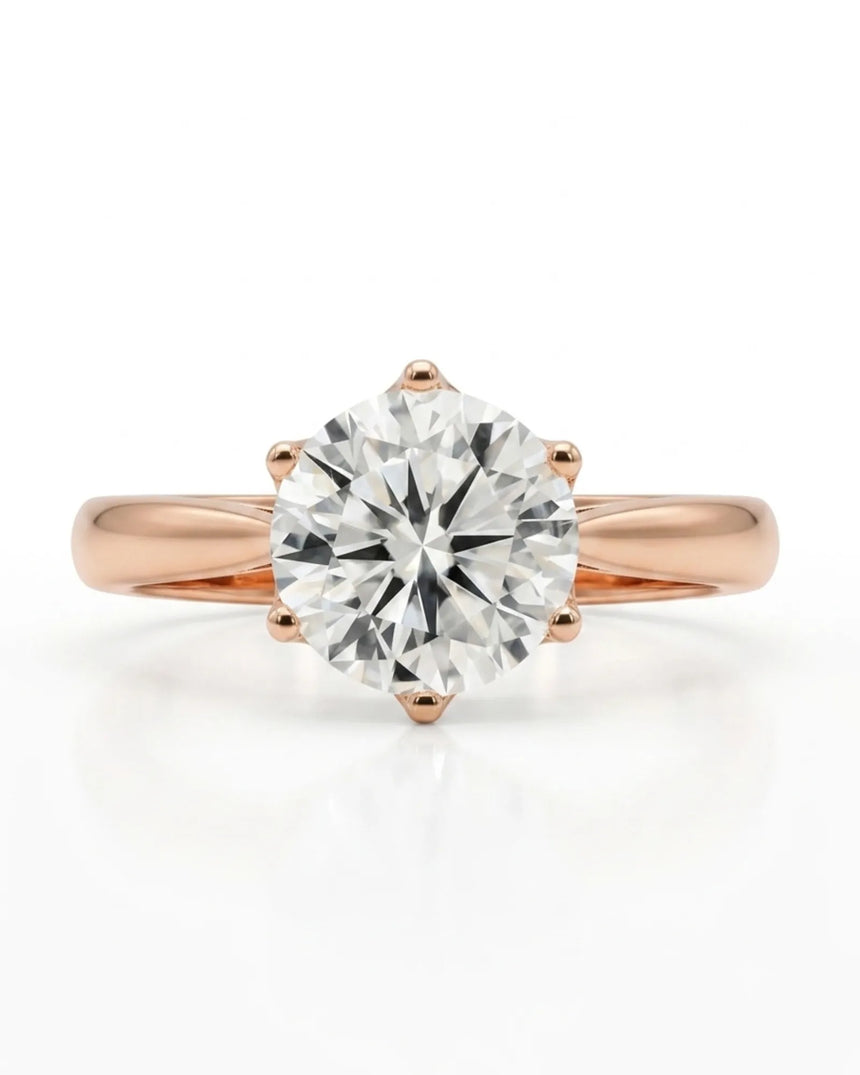 Colorless round moissanite solitaire ring with warm rose gold six-prong crown | SARATTI