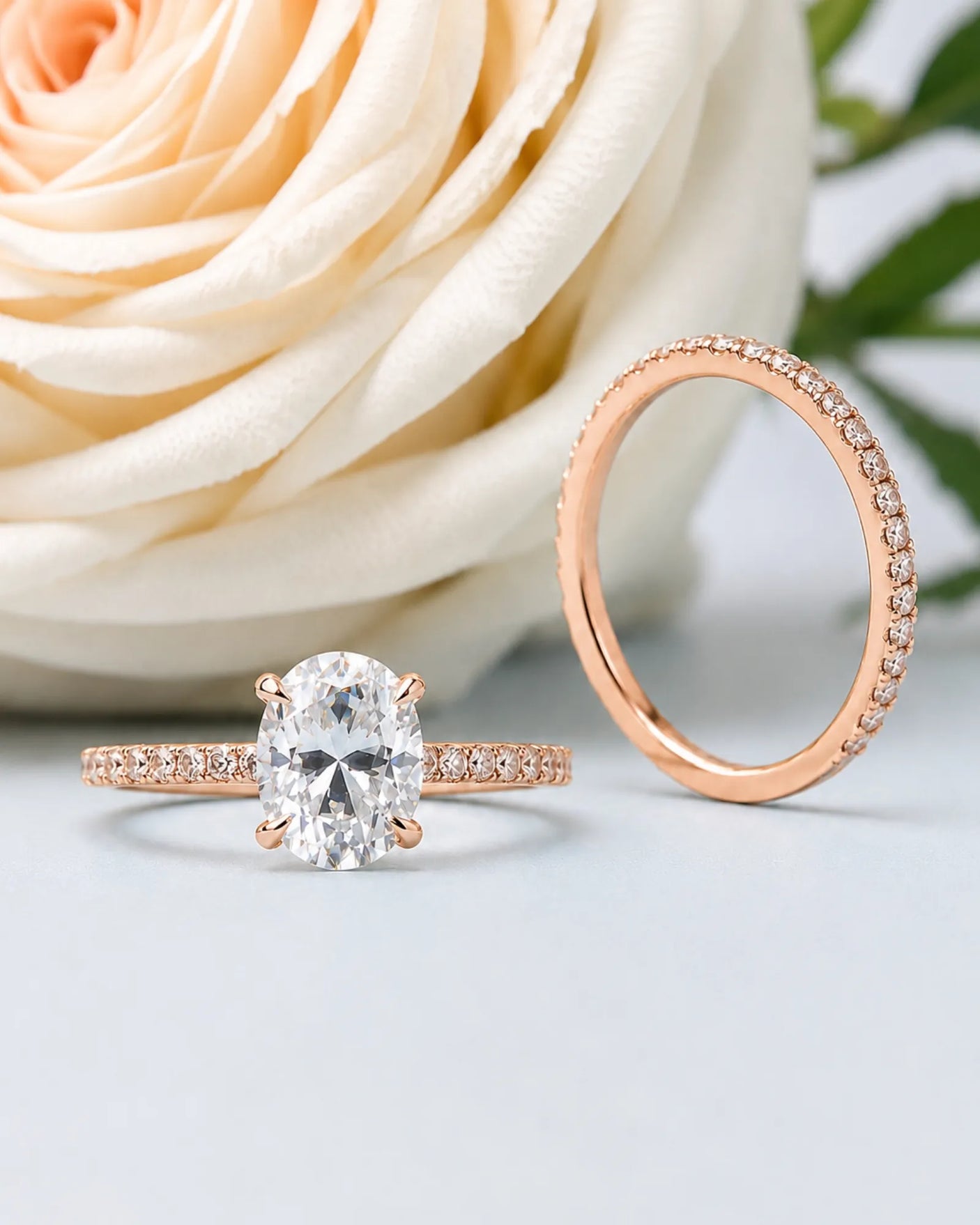 Coordinated oval moissanite ring set with parallel pavé bands and hidden halo in 18K rose gold | SARATTI