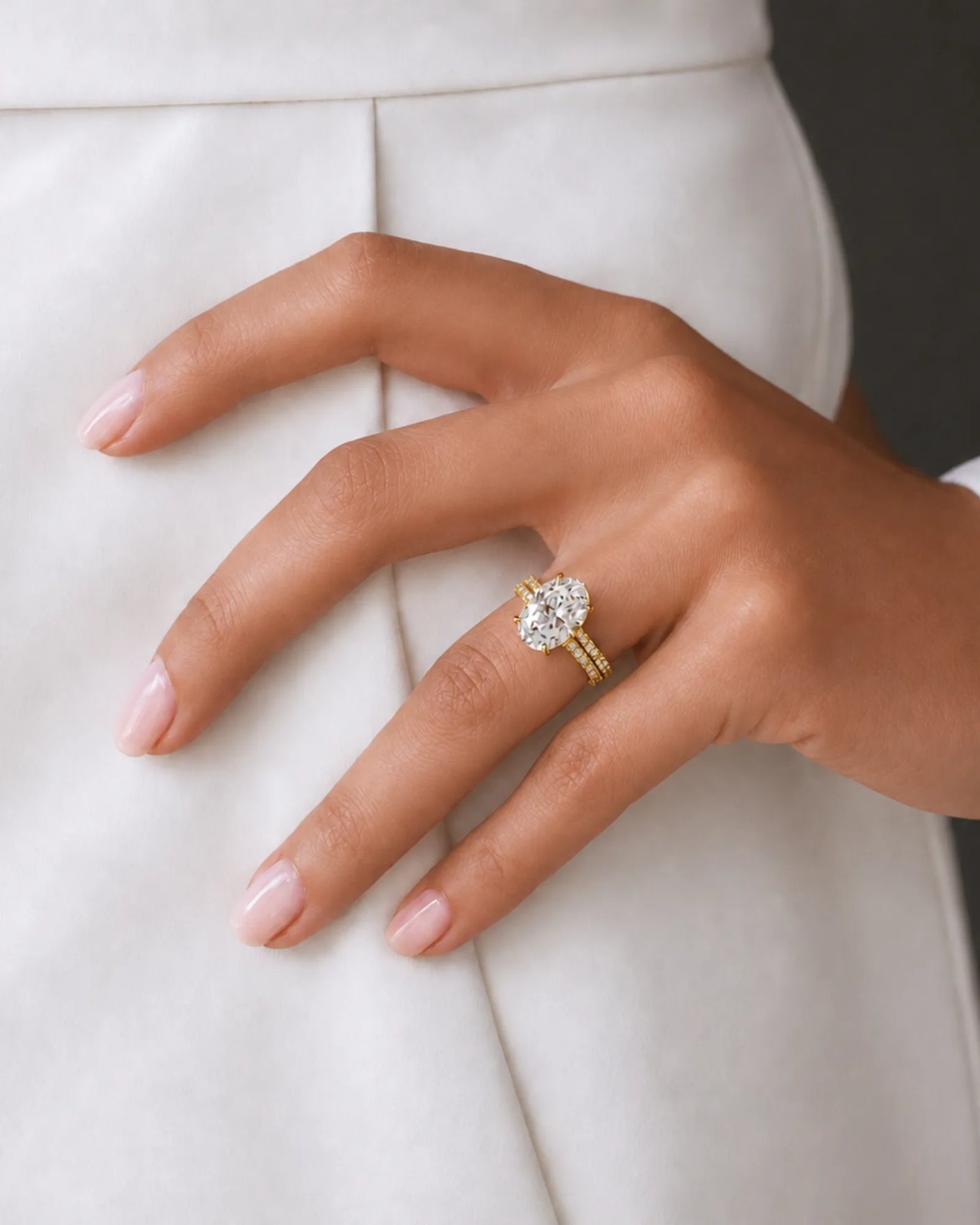 Coordinated oval moissanite ring set with parallel pavé bands and hidden halo in 18K yellow gold | SARATTI