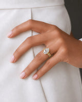 Coordinated oval moissanite ring set with parallel pavé bands and hidden halo in 18K yellow gold | SARATTI
