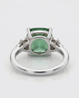 Cushion-cut green tourmaline ring with round diamond accents in a timeless platinum design | SARATTI