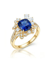Cushion-cut royal blue sapphire ring with floral diamond halo in 18K yellow gold | SARATTI