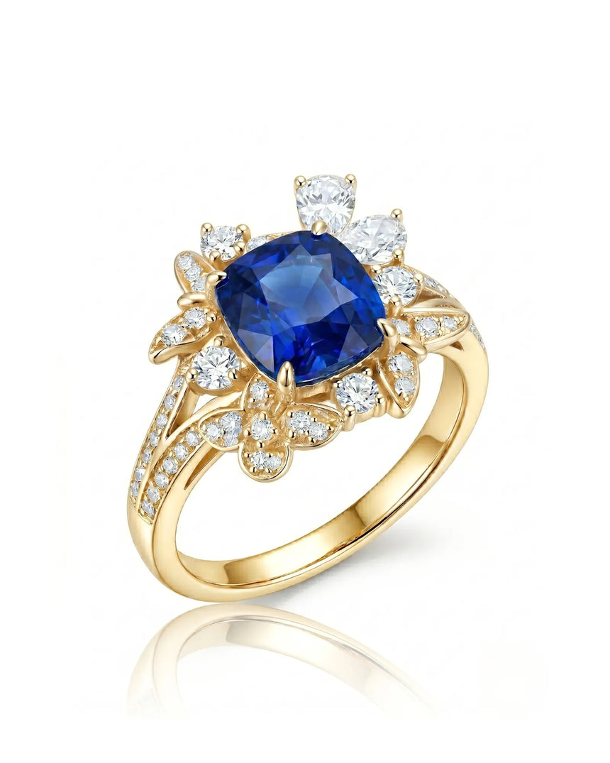 Cushion-cut royal blue sapphire ring with floral diamond halo in 18K yellow gold | SARATTI