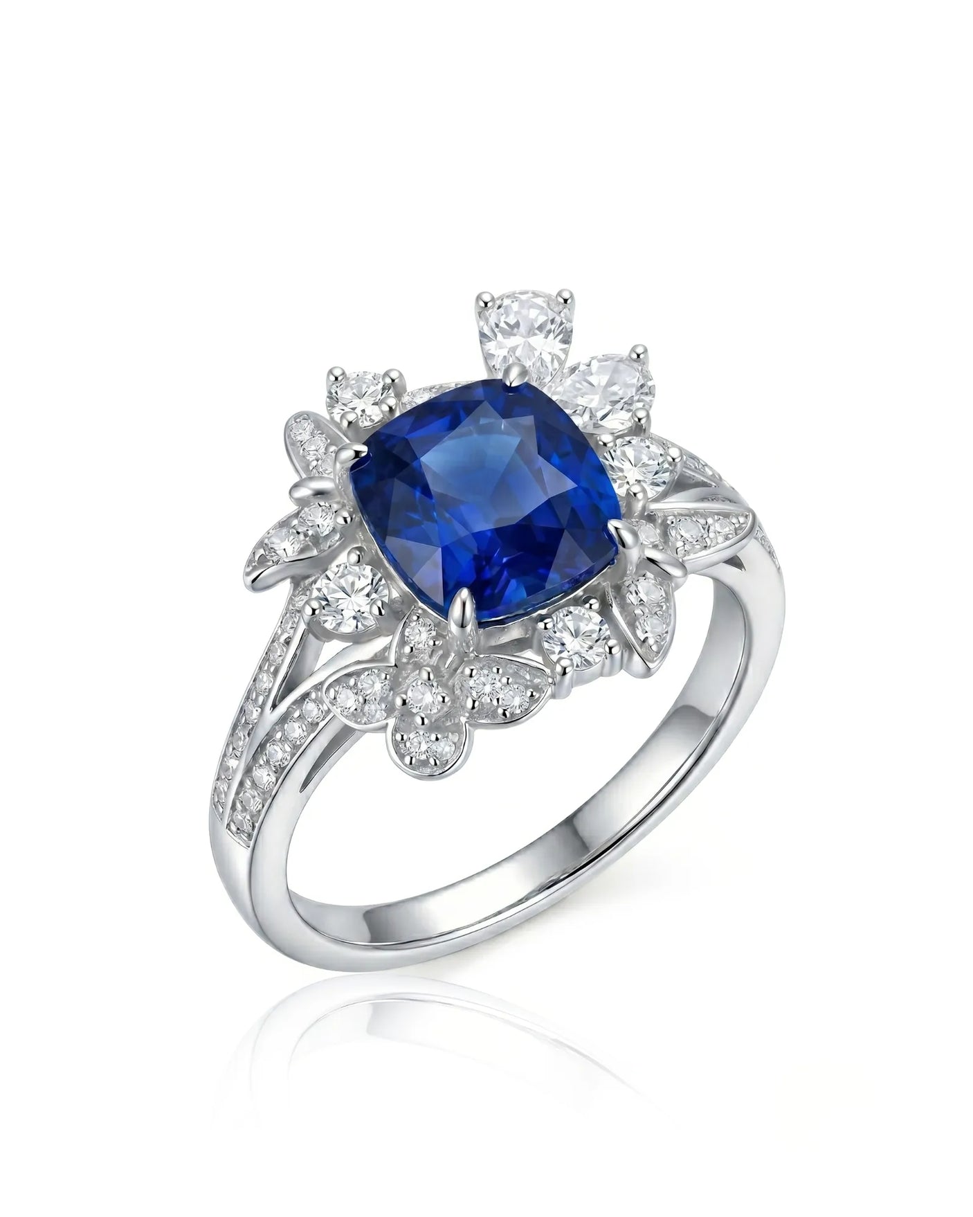 Cushion-cut royal blue sapphire ring with floral diamond halo in platinum | SARATTI